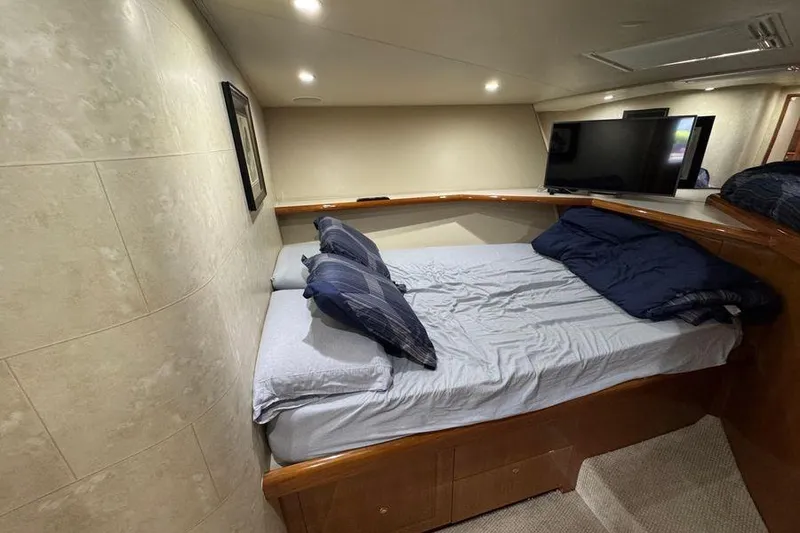 Slide: The Image of Cozy bedroom interior of 2002 Viking 61 Enclosed Bridge yacht with modern amenities. - 101