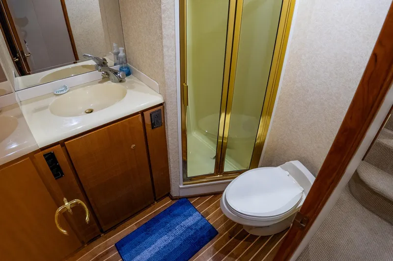 Slide: The Image of Luxurious bathroom in 2002 Viking 61 Enclosed Bridge yacht with shower and toilet. - 103