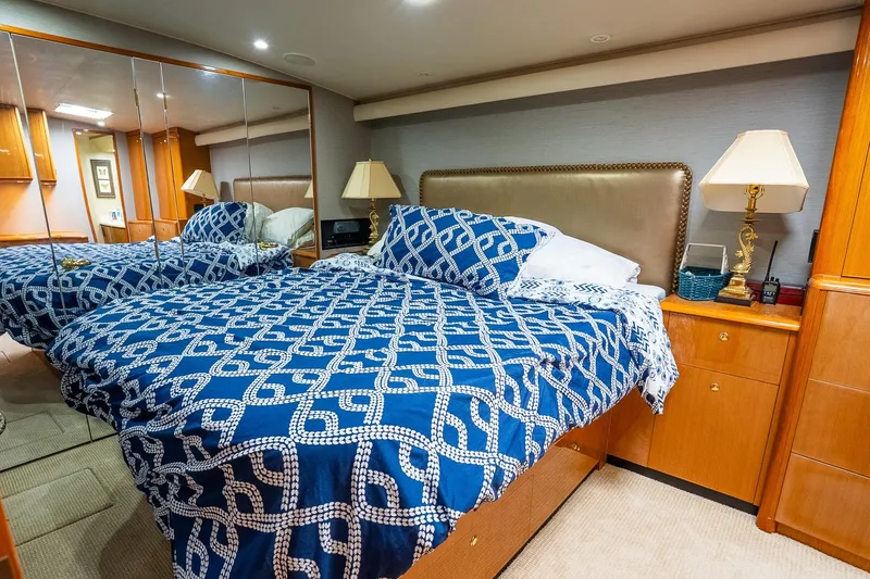 Slide: The Image of Luxurious bedroom interior on 2002 Viking 61 Enclosed Bridge yacht with elegant decor. - 105