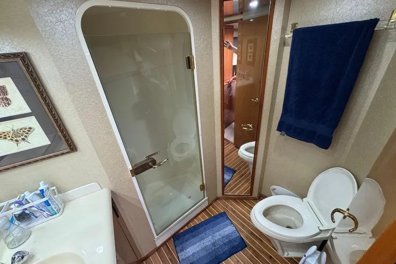 Slide: The Image of Bathroom interior of 2002 Viking 61 Enclosed Bridge yacht with shower and toilet. - 108
