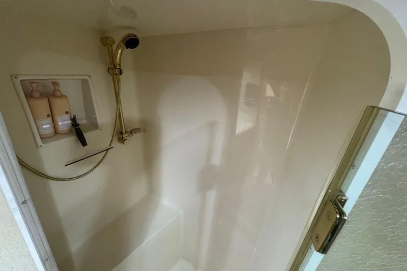 Slide: The Image of Shower area in 2002 Viking 61 Enclosed Bridge yacht with built-in toiletries. - 110
