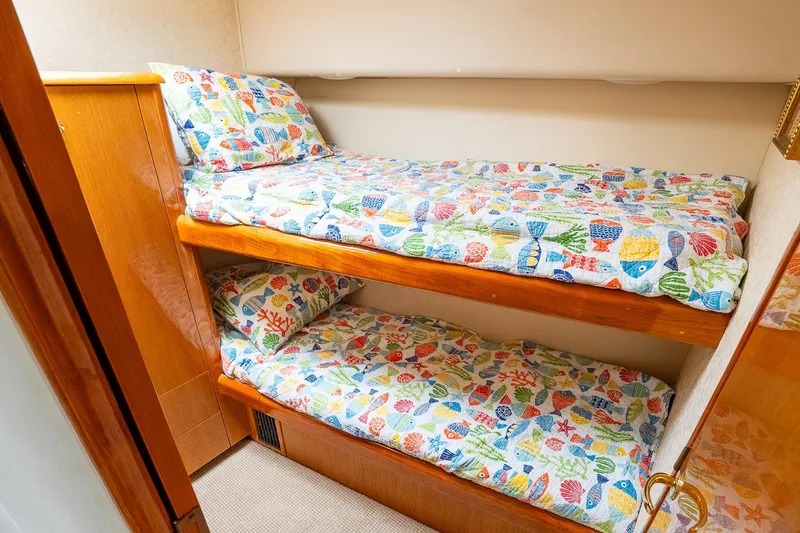 Slide: The Image of Bunk beds with colorful fish-themed bedding in 2002 Viking 61 Enclosed Bridge yacht. - 111