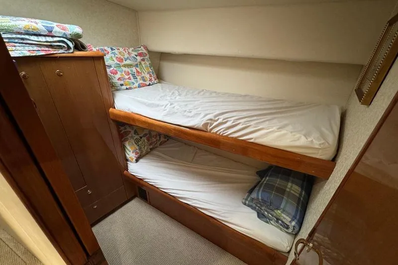 Slide: The Image of Bunk beds in 2002 Viking 61 Enclosed Bridge yacht cabin with colorful bedding. - 112