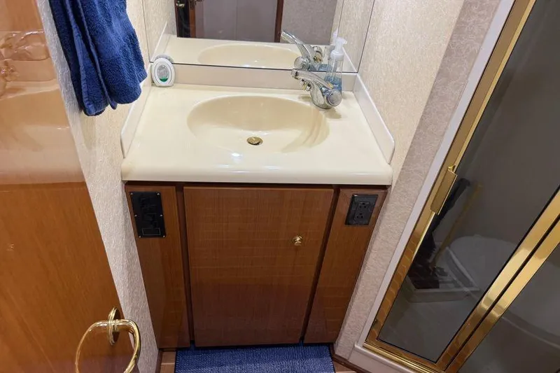 Slide: The Image of Bathroom vanity and shower in 2002 Viking 61 Enclosed Bridge yacht. - 113