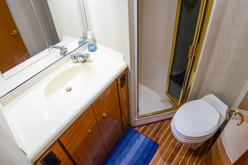 Slide: The Image of Bathroom interior of 2002 Viking 61 Enclosed Bridge yacht with shower, sink, and toilet. - 115