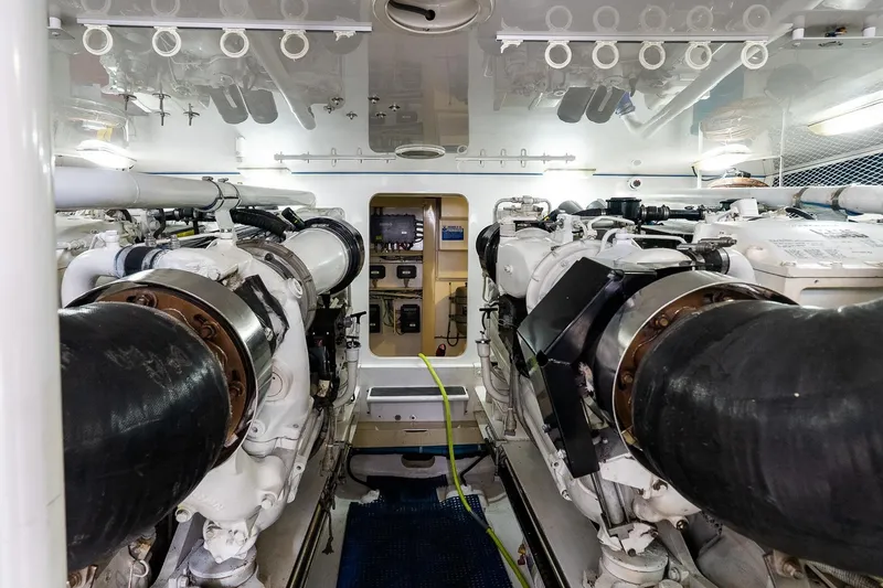 Slide: The Image of Engine room of 2002 Viking 61 Enclosed Bridge yacht, showcasing dual engines and equipment. - 117