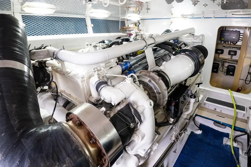 Slide: The Image of Engine room of a 2002 Viking 61 Enclosed Bridge yacht, showcasing machinery and components. - 118