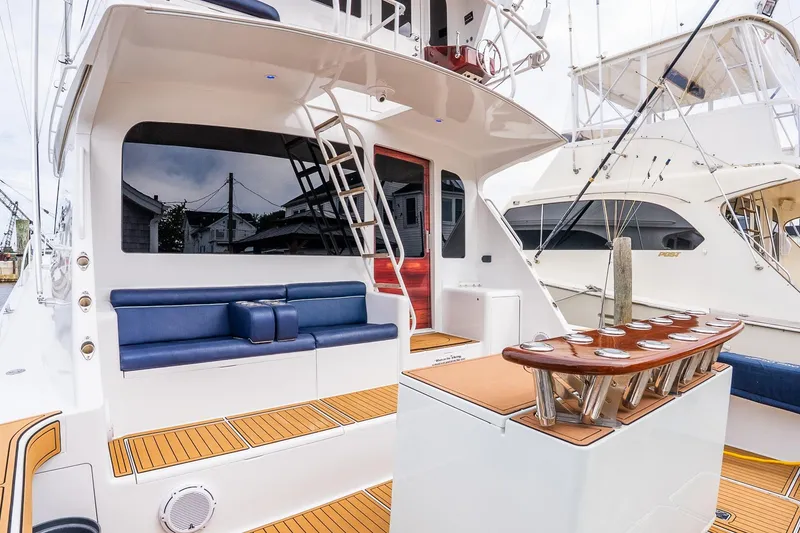 Slide: The Image of 2002 Viking 61 Enclosed Bridge yacht with sleek seating and fishing rod holders. - 12