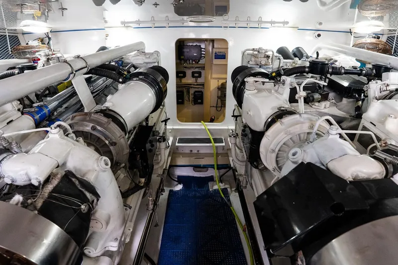 Slide: The Image of Engine room of 2002 Viking 61 Enclosed Bridge yacht, showcasing dual engines and mechanical systems. - 120