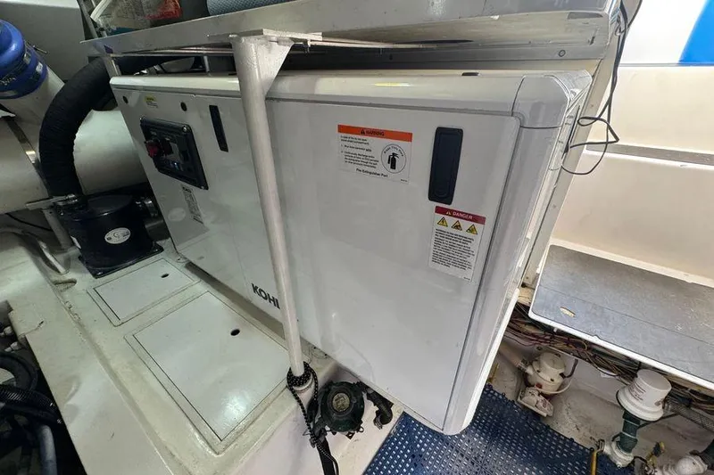 Slide: The Image of Engine room of 2002 Viking 61 Enclosed Bridge yacht with Kohler generator. - 124