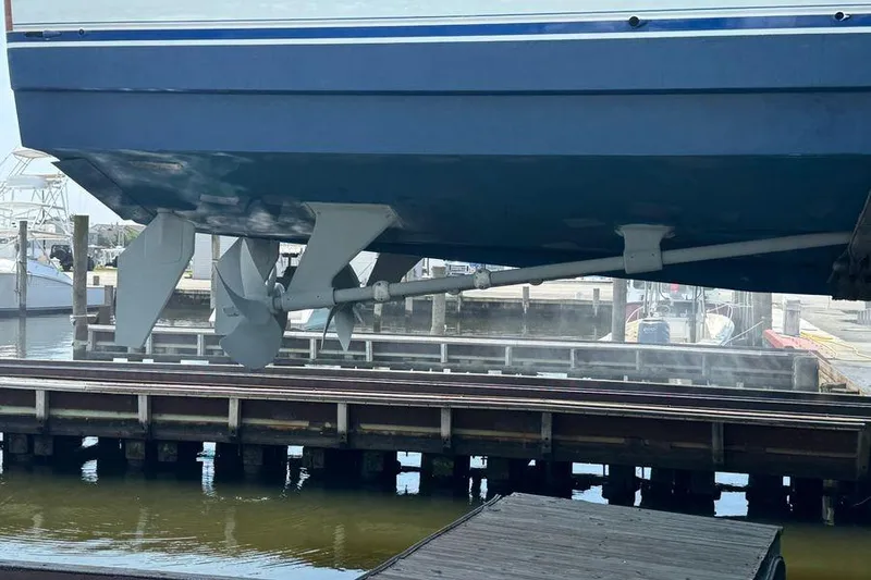 Slide: The Image of 2002 Viking 61 Enclosed Bridge yacht hull and propellers at dockside. - 126