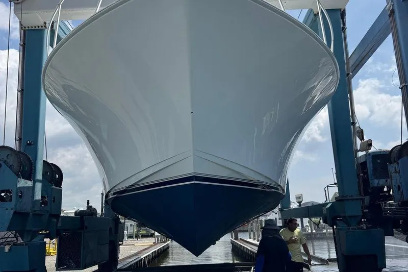 Slide: The Image of 2002 Viking 61 Enclosed Bridge yacht in dry dock, viewed from the front. - 127