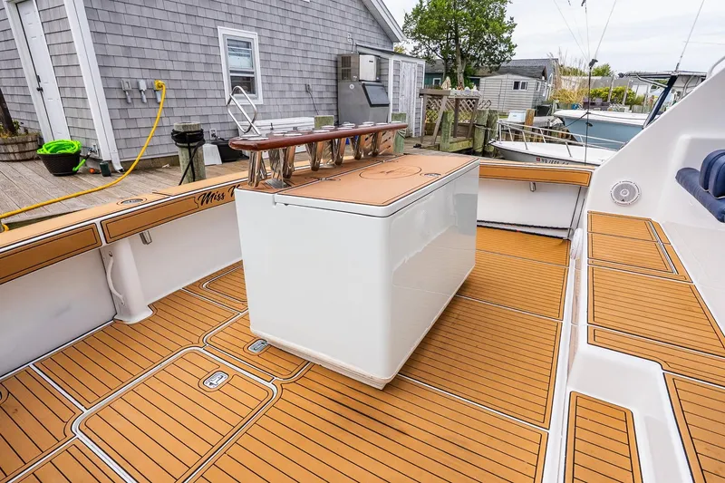 Slide: The Image of 2002 Viking 61 Enclosed Bridge yacht deck with teak flooring and fishing station. - 16