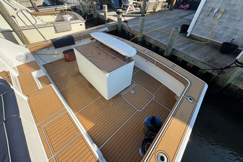 Slide: The Image of 2002 Viking 61 Enclosed Bridge yacht with teak deck at dock. - 18