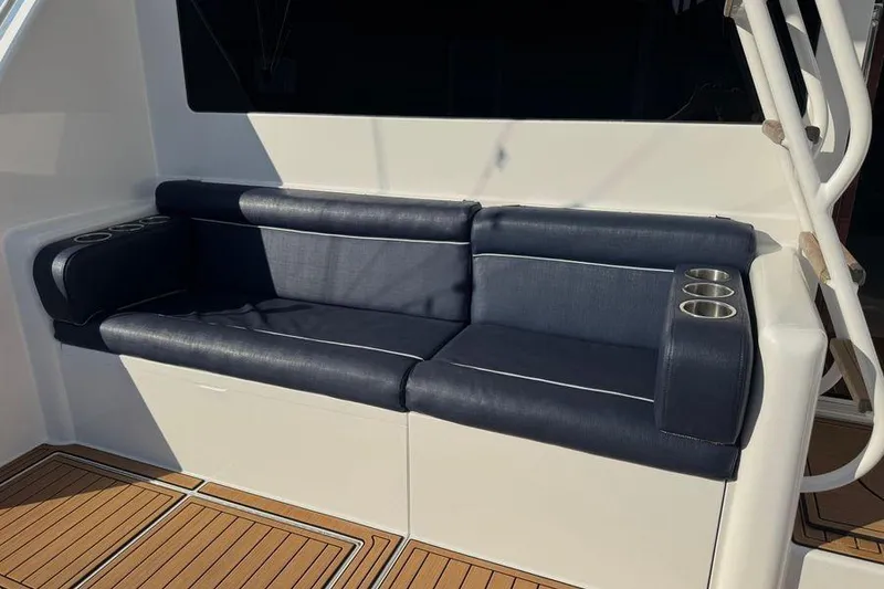 Slide: The Image of 2002 Viking 61 Enclosed Bridge yacht seating with cup holders on teak deck. - 20