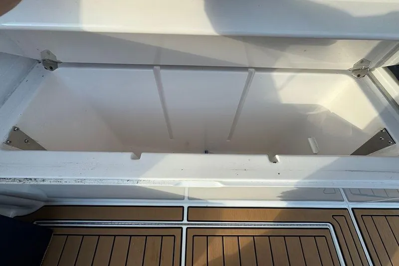 Slide: The Image of Open storage compartment on 2002 Viking 61 Enclosed Bridge yacht, featuring teak flooring. - 21