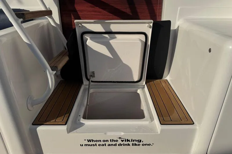 Slide: The Image of 2002 Viking 61 Enclosed Bridge boat with open storage compartment and humorous quote. - 22