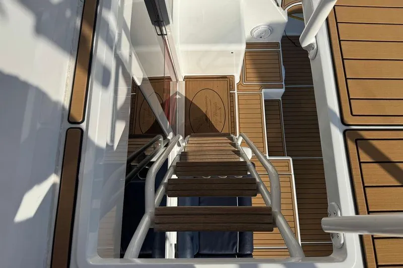 Slide: The Image of Staircase view on 2002 Viking 61 Enclosed Bridge yacht with teak flooring. - 25