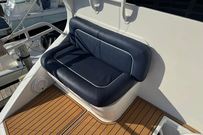 Slide: The Image of Blue cushioned seating on 2002 Viking 61 Enclosed Bridge yacht deck. - 28
