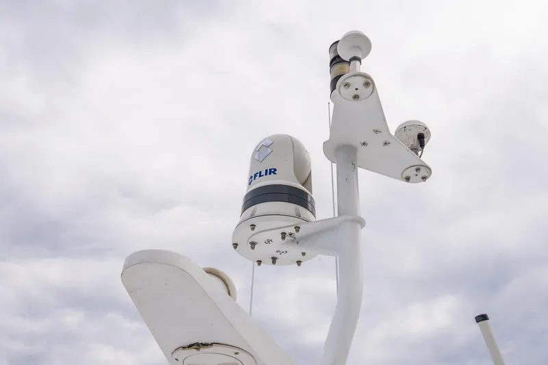 Slide: The Image of Radar and camera equipment on 2002 Viking 61 Enclosed Bridge yacht against cloudy sky. - 30