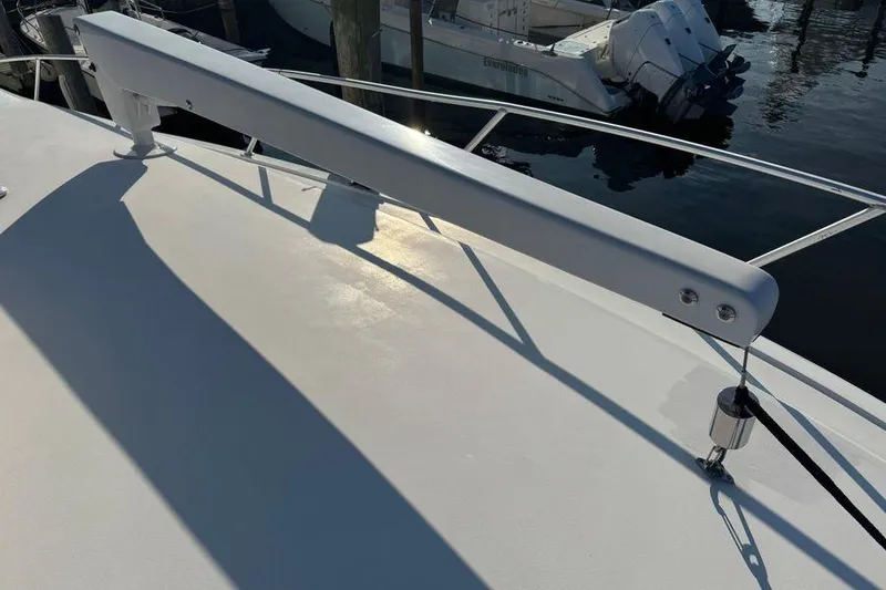 Slide: The Image of 2002 Viking 61 Enclosed Bridge yacht deck with railing and davit system. - 37