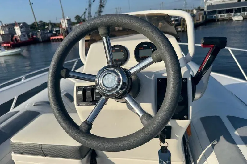 Slide: The Image of Steering wheel of a 2002 Viking 61 Enclosed Bridge yacht, docked at a marina. - 44