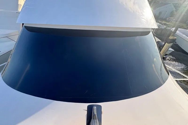 Slide: The Image of 2002 Viking 61 Enclosed Bridge yacht with sleek tinted windows. - 46