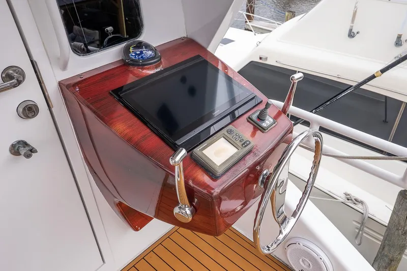 Slide: The Image of Control panel of 2002 Viking 61 Enclosed Bridge yacht with steering wheel and navigation equipment. - 49