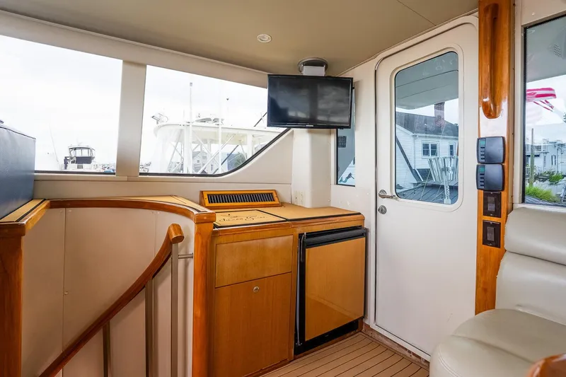 Slide: The Image of Interior of a 2002 Viking 61 Enclosed Bridge yacht with wood accents and modern amenities. - 51