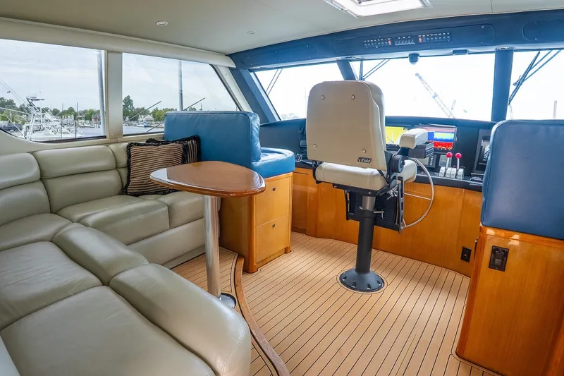 Slide: The Image of Luxurious interior of 2002 Viking 61 Enclosed Bridge yacht with leather seating and navigation controls. - 57