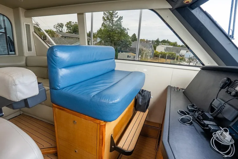 Slide: The Image of Interior of 2002 Viking 61 Enclosed Bridge yacht with blue seating and navigation equipment. - 59