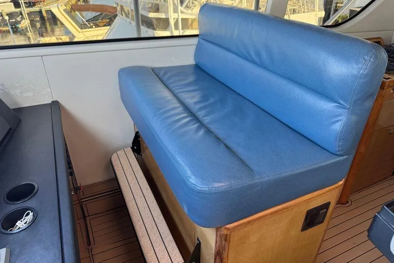 Slide: The Image of Blue leather seating on 2002 Viking 61 Enclosed Bridge yacht interior. - 62