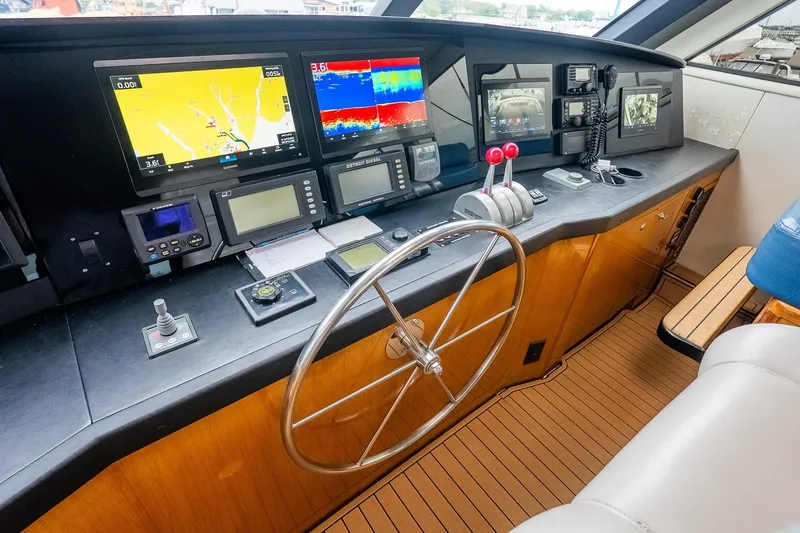 Slide: The Image of Control panel of 2002 Viking 61 Enclosed Bridge yacht with navigation equipment. - 63