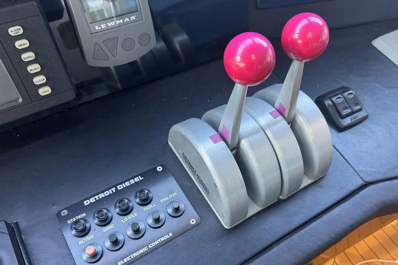 Slide: The Image of Control panel of a 2002 Viking 61 Enclosed Bridge yacht with throttle levers. - 66