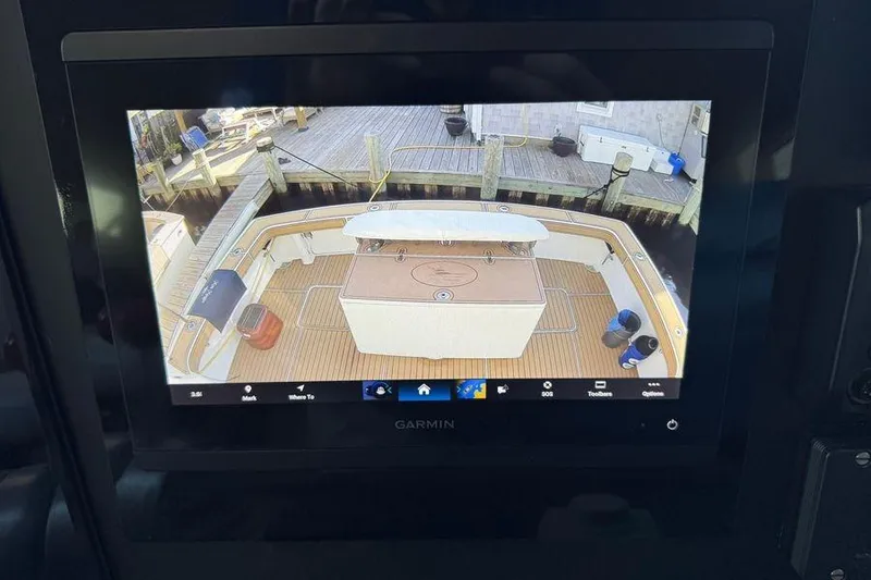 Slide: The Image of Garmin display showing 2002 Viking 61 Enclosed Bridge yacht deck view at dock. - 70