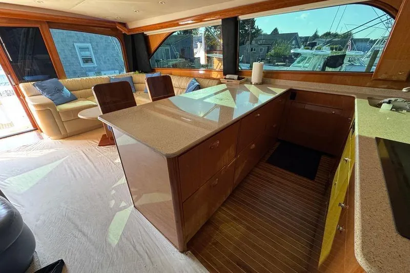 Slide: The Image of Luxurious interior of 2002 Viking 61 Enclosed Bridge yacht with spacious seating and modern kitchen. - 85