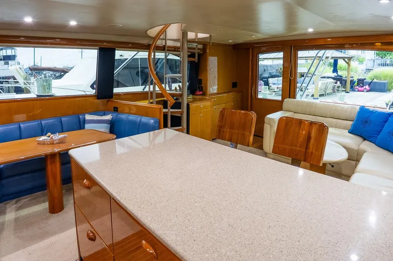 Slide: The Image of Luxurious interior of 2002 Viking 61 Enclosed Bridge yacht with elegant seating and dining area. - 87