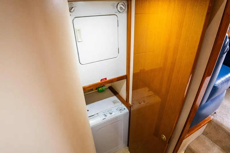 Slide: The Image of Laundry area on 2002 Viking 61 Enclosed Bridge yacht with stacked washer and dryer. - 94