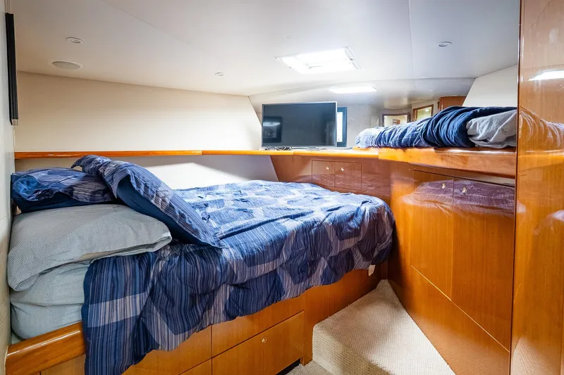 Slide: The Image of Luxurious cabin interior of 2002 Viking 61 Enclosed Bridge yacht with cozy bedding. - 98