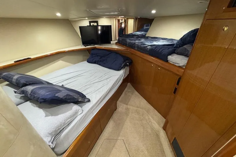 Slide: The Image of Interior cabin of 2002 Viking 61 Enclosed Bridge yacht with twin beds and TV. - 99