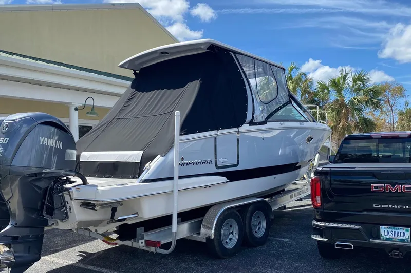 Slide: The Image of 2022 Chaparral 280 OSX boat on trailer, parked beside a GMC truck. - 3