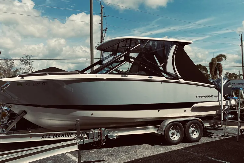Slide: The Image of 2022 Chaparral 280 OSX boat on trailer under blue sky. - 4