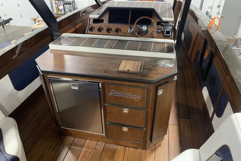 Slide: The Image of 2023 StanCraft 340 Hammerhead Center Console with elegant wood finish and modern amenities. - 11