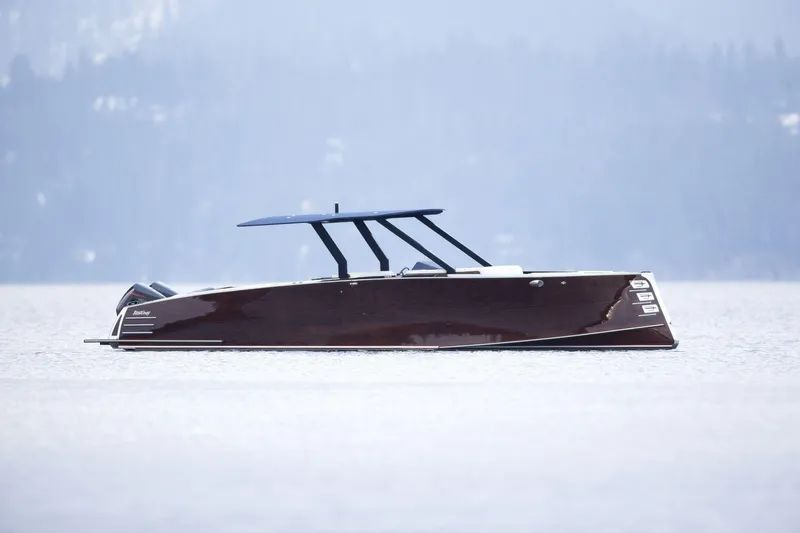 Slide: The Image of 2023 StanCraft 340 Hammerhead Center Console boat on calm water. - 2