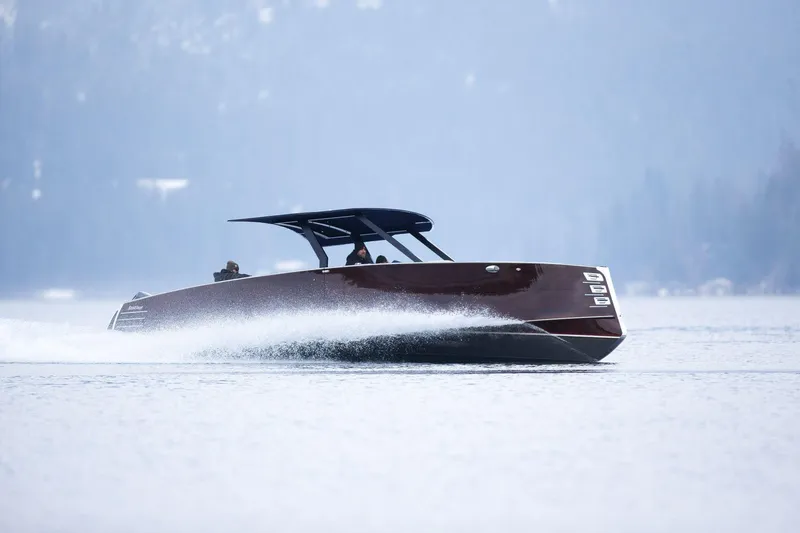 Slide: The Image of 2023 StanCraft 340 Hammerhead Center Console cruising on a serene lake. - 6