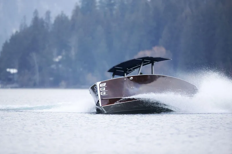 Slide: The Image of 2023 StanCraft 340 Hammerhead Center Console cruising on a lake with forest backdrop. - 7