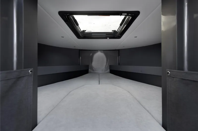 Slide: The Image of Interior cabin of 2026 Jasper Marine Defender 22 boat, featuring a skylight. - 25