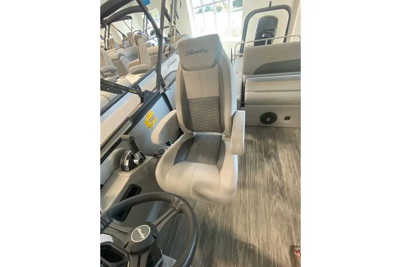 Slide: The Image of 2026 Bentley Pontoons Legacy 223 Swingback interior with luxurious seating and steering wheel. - 12