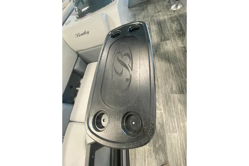 Slide: The Image of 2026 Bentley Pontoons Legacy 223 Swingback interior with sleek black table and cup holders. - 18