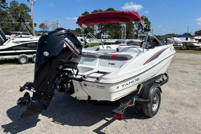 Slide: The Image of 2020 Tahoe T16 boat with Mercury engine on trailer, parked outdoors. - 63